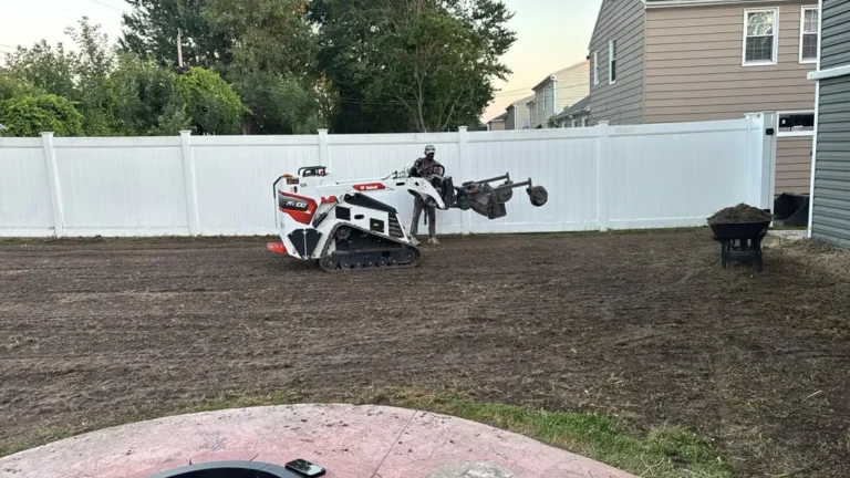Skid steer grading a backyard for a new lawn in Buffalo NY