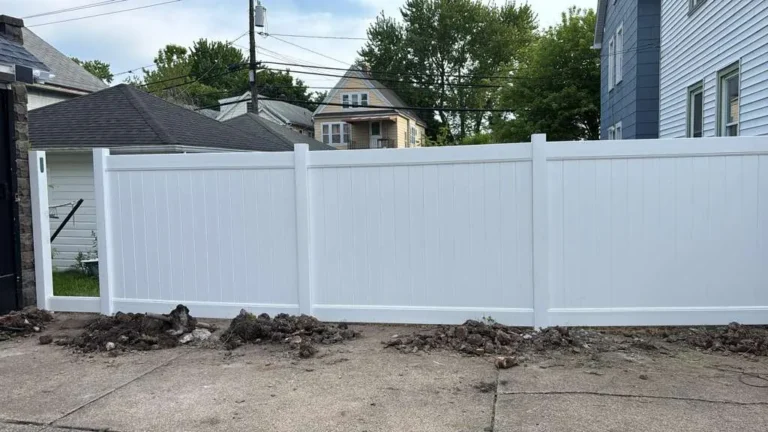 New white vinyl privacy fence installed behind a Buffalo home